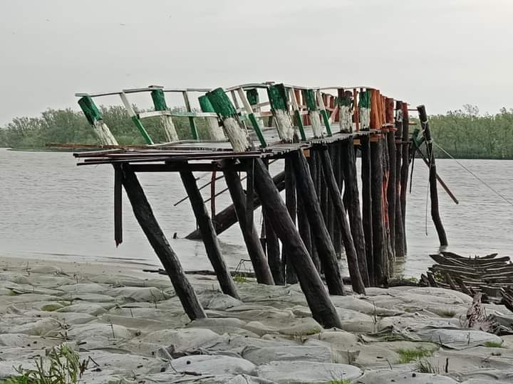 The image shows the Forest Department jetty in the Sundarbans being damaged by the impact of Cyclone Remal. Photo By: A H Sumon  